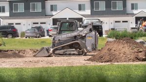 Bobcat T66 skid steer with custom Deviant Ink wrap working on a residential excavation site
