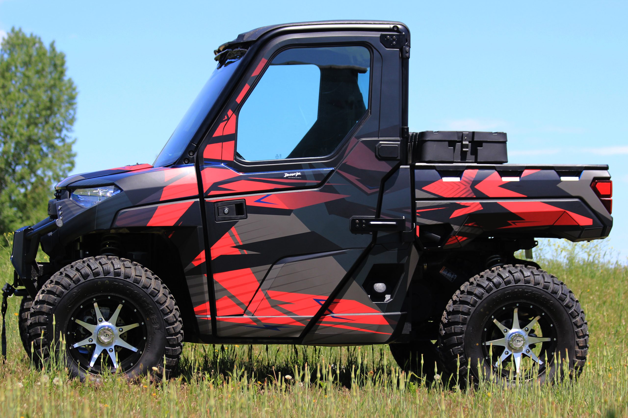 Side view of Polaris Ranger featuring Deviant Ink’s Terminal wrap in red, black, and grey