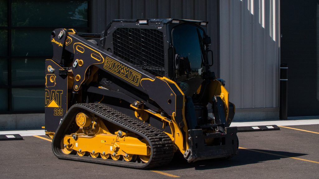CAT 265 compact track loader with custom black and yellow Summit wrap by Deviant Ink