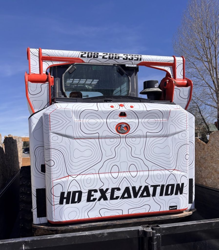 Back of HD Excavation Kubota skid steer with Elevation wrap design by Deviant Ink
